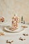 Vertical shot of a delicious Christmas cake with gingerbread decorations and coconutâ€“almond ball