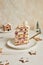Vertical shot of a delicious Christmas cake with gingerbread decorations and coconutâ€“almond ball