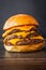 Vertical shot of a delicious juicy burger with triple patty on a wooden table