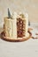 Vertical shot of a delicious layered Christmas drip cake on a wooden plate