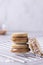 Vertical shot of delicious macarons of various fillings stacked on a grid