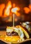 Vertical shot of a delicious open burger with fresh ingredients attached with skewers stick