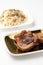 Vertical shot of deliciously grilled pork meat on a plate isolated on a white background