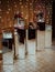 Vertical shot of a dessert corner of a restaurant with sweets and flower decors put on mirror tables