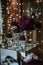 Vertical shot of a dessert corner of a restaurant with sweets and flower put on a mirror table