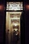 Vertical shot of a dimly lit doorway entrance of an apartment building