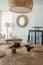 Vertical shot of a dinner table with a small charcuterie board and glasses of wine in a living room