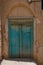 Vertical shot of a dusty turquoise wooden entrance door