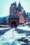 Vertical shot of the Eltz Castle in Wierschem Germany in winter with a small snowman in the front