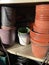 Vertical shot of empty buckets stacked on each other on the shelves