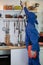 Vertical shot of an engineer in a blue costume and an anti-gas mask working in the kitchen