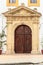 Vertical shot of the entrance door of a colonial church in Cartagena, Colombia
