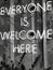 Vertical shot of Everyone is welcome here sign