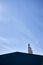 Vertical shot of factory towers and the blue sky in the background