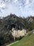 Vertical shot of the famous Predjama Castle in Slovenia under a cloudy sky