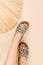 Vertical shot of fashionable flat beige sandals with a leopard pattern