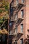 Vertical shot of a fire escape staircase of a brick building in New York, United States.