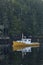 Vertical shot of a fishing boat moored with its reflect on the water