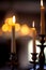 Vertical shot of flaming white candles with a blurred background