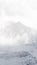 Vertical shot of foggy snow-covered mountains in Bormio, Italy