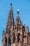 Vertical shot of the Freiburger Munster cathedral against a blue sky.
