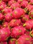 Vertical shot of fresh Pitaya fruits in a bunch in the market