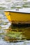 Vertical shot of the front yellow detail of a boat on the water