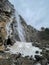 Vertical shot of the frozen Pissevache waterfall in Switzerland