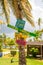 Vertical shot of fun beach signs on a coconut tree trunk