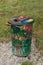 Vertical shot of a garbage can in the park