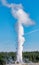 Vertical shot of Geyser Old Faithful exploding, Yellowstone National Park, USA