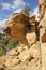 Vertical shot of a giant rock with a narrow brick staircase and a sign banning stepping on the site