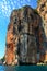 Vertical shot of a giant rocky cliff under the cloudy blue sky in Mu Ko Phiphi, Thailand