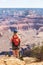 Vertical shot of a girl hiker gazing at the mountains at the Grand Canyon, Arizona, USA