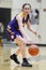 Vertical shot of a girl playing basketball during the girls fall high school tournament in Australia
