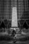 Vertical shot of a girl walking on the square of the glassy building of One PPG Place, Pittsburgh