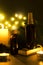 Vertical shot of glass bottles of oils, stones, candles and warm lights as a background. Spa treatments concept