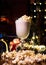 Vertical shot of a glass of eggnog served with popcorn
