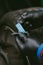 Vertical shot of gloved hands of a worker wrapping blue duct tape on a metal bar