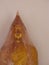 Vertical shot of a golden statue of Buddha covered and protected with plastic