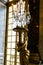 Vertical shot of a golden statue in the Hall of Mirrors in Versailles Palace in France