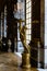 Vertical shot of a golden statue in the Hall of Mirrors in Versailles Palace in France