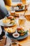 Vertical shot of a gourmet fast food restaurant table with burgers, fries, and drinks