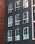 Vertical shot of a grey building with a lot of windows - great for a background