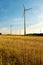 Vertical shot of a group of wind turbines in the golden field