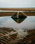 Vertical shot of a half-submerged stone on a North Wales beach