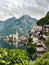 Vertical shot of Hallstatt on a shore of a lake in green mountains in Austria