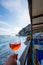 Vertical shot of a hand holding a glass with drink at Positano Amalfi coast in Italy