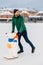 Vertical shot of handsome bearded male being on ice rink, learns