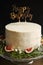 Vertical shot of a  happy birthday dream cake with white cream with a black background